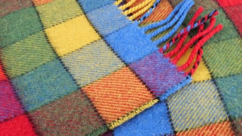 Top view on the bright textured multicolored wool fabric in a large check rotated