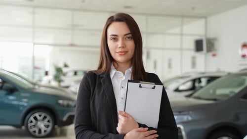 Portrait of Female Car Dealer in Car Dealership