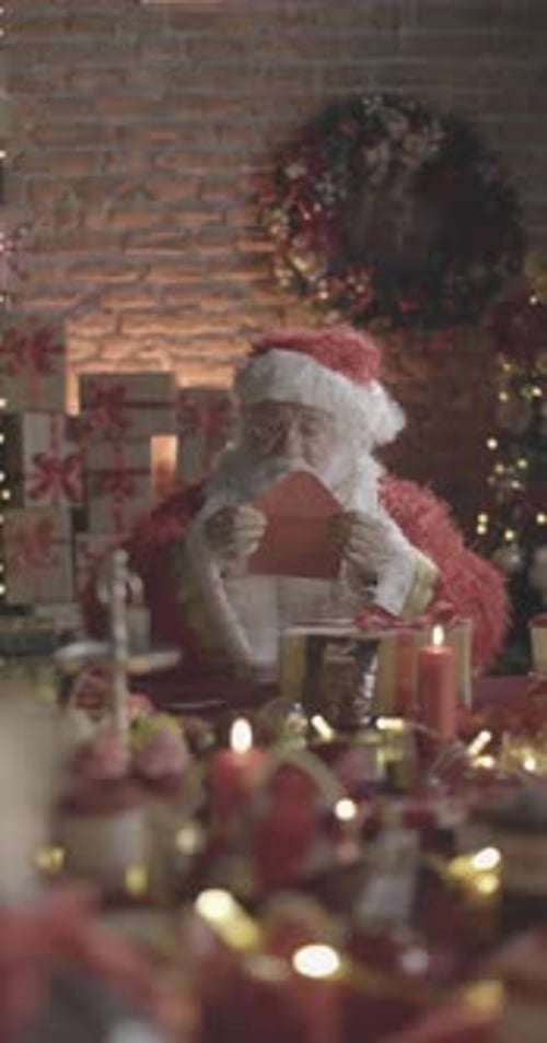 Santa Claus reading envelope