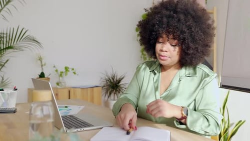 Young Latin American Businesswoman Working on Laptop at Bright Modern Office