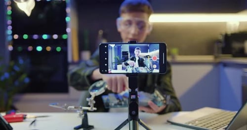 Teen Records Tech Video at Home at Night