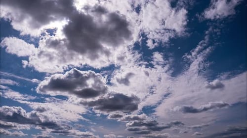 Timelapse of Fluffy Clouds Moving Under the Sun in the Blue Sky