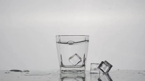 Ice Cubes Plunging into a Refreshing Glass of Water