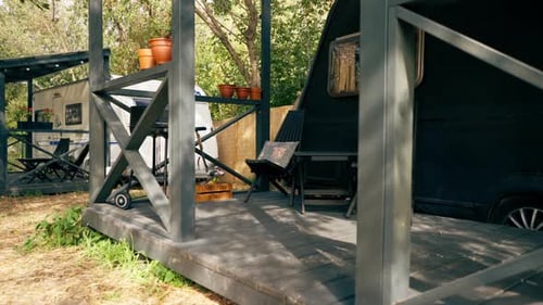 A mobile home with a terrace is located in country glamping site for relaxation and solitude nature