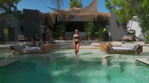 Aerial View Model in Swimsuit Enjoying BaliInspired Beach Club By the Sea