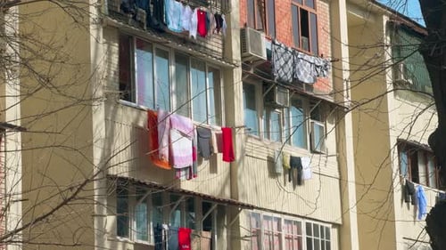 View of a residential building with clothes drying.