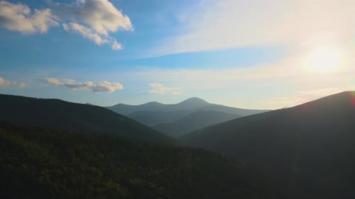 Aerial View of Bright Foggy Morning Over Dark Hills with Mountain Forest Trees at Autumn Sunrise