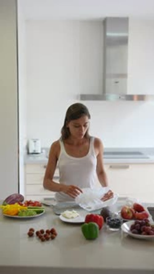 Woman Prepares Food at Kitchen Island