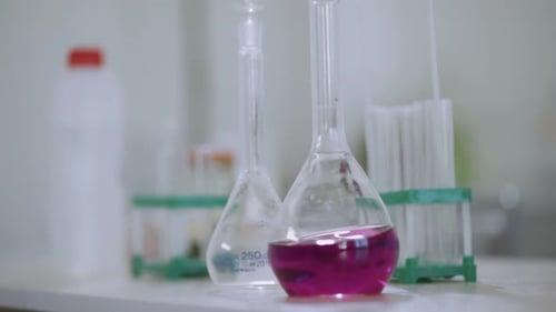 Laboratory Glassware with Pink Liquid for Research