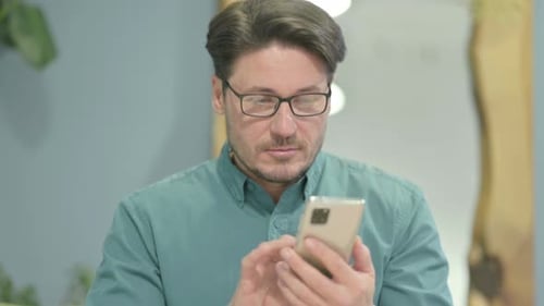 Man Using Smartphone Indoors Close Up
