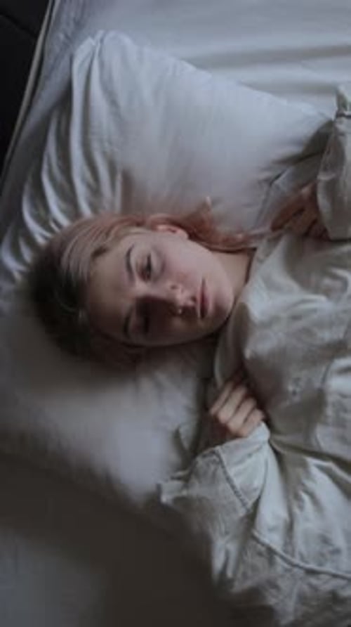 Depressed Young Woman Lying on Bed Female Insomnia at Night Vertical Video