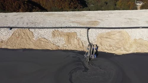 Aerial View of Mining Residuals Flowing into Decanting Pond from a Copper Mine. Geamana, Romania