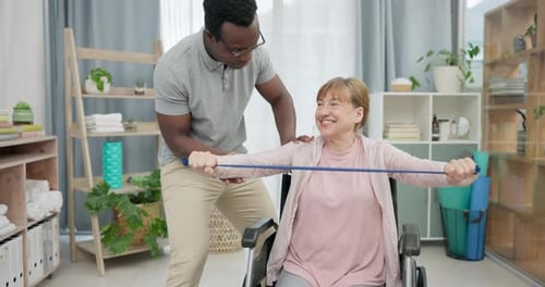 Woman in Wheelchair Exercising with Resistance Band