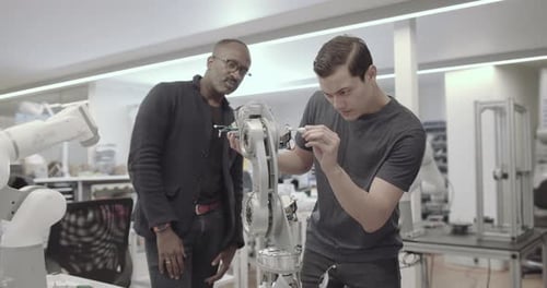 Engineers working on a robotic arm