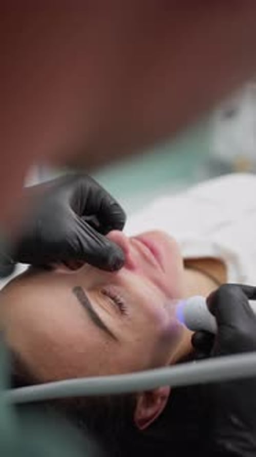 Woman Receiving Facial Treatment in Vertical Close Up