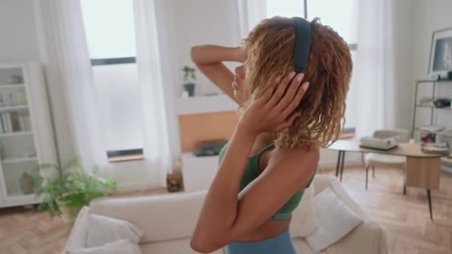 Woman Enjoys Music and Dances at Home