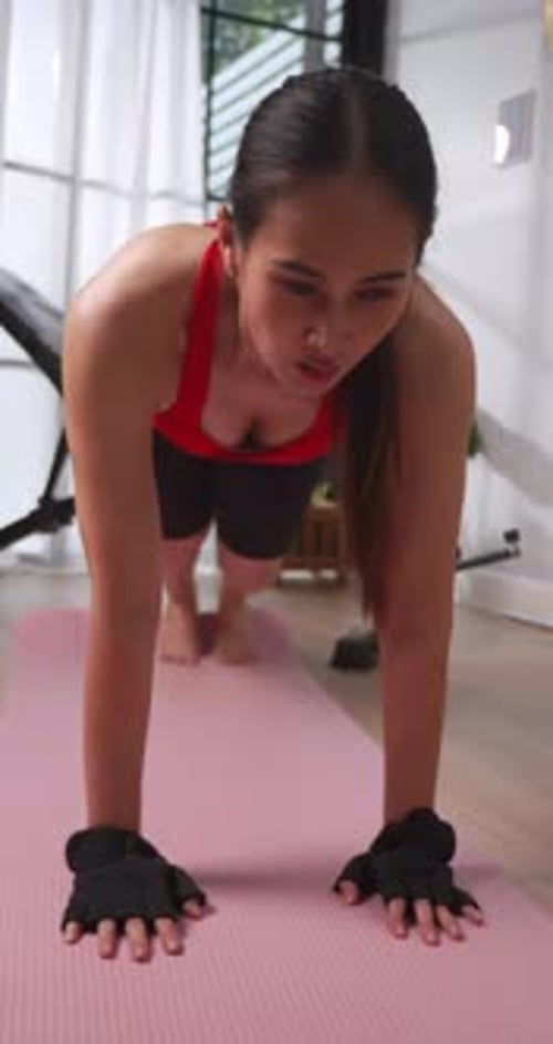 Woman Doing Mountain Climbers on Yoga Mat