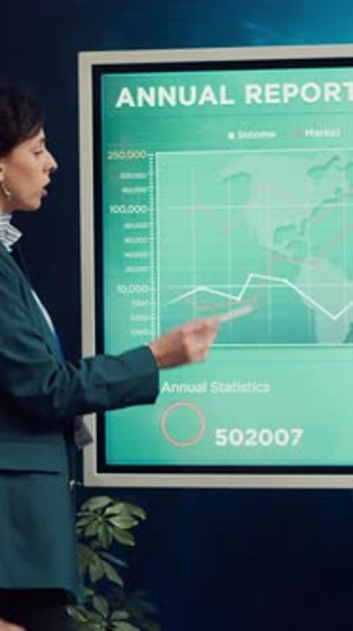 Woman Presents Business Analytics on Interactive Screen