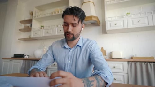 Man Working Remotely on Video Call in Kitchen