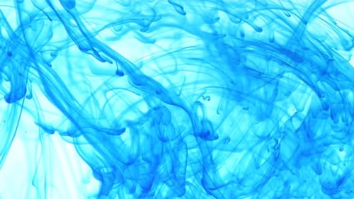 Abstract flowing blue dye on white background