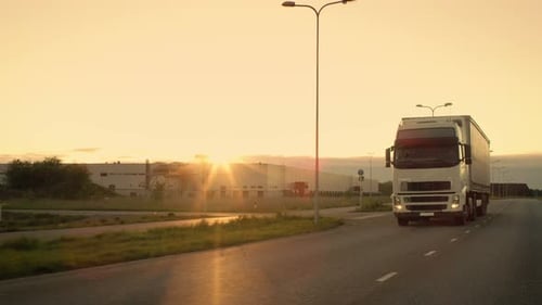 Front-View Camera Follows Semi-Truck with Cargo Trailer Driving on a Highway. He's Speeding Through