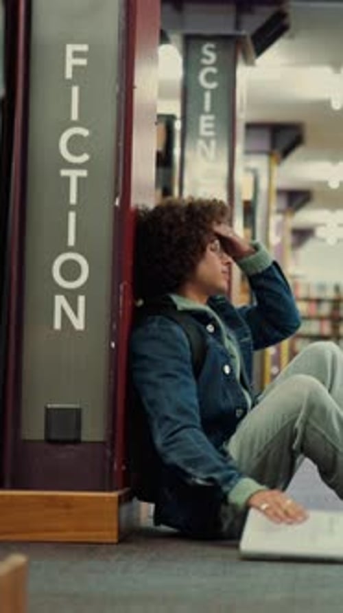 Man, library and frustrated student with stress, exam fail or education pressure in college