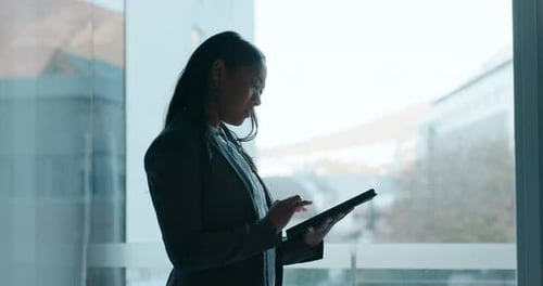 Business Woman Using Tablet in Modern Office Setting