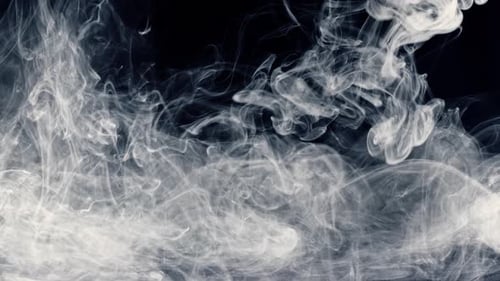 White Smoke Flowing on a Black Background