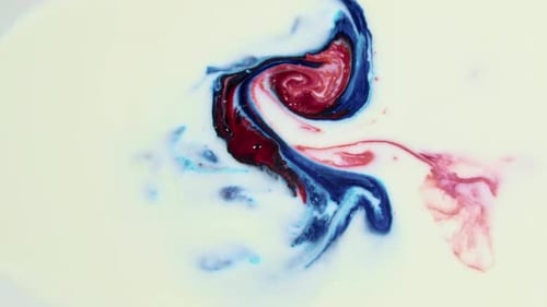 Dynamic Red and Blue Ink Swirls in Liquid