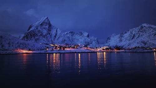 Aerial Perspective of Sea Snowy Mountains and Rorbuer During Winter Night in Lofoten Islands Norway