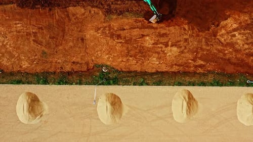 Aerial view of excavator digging dirt at construction site