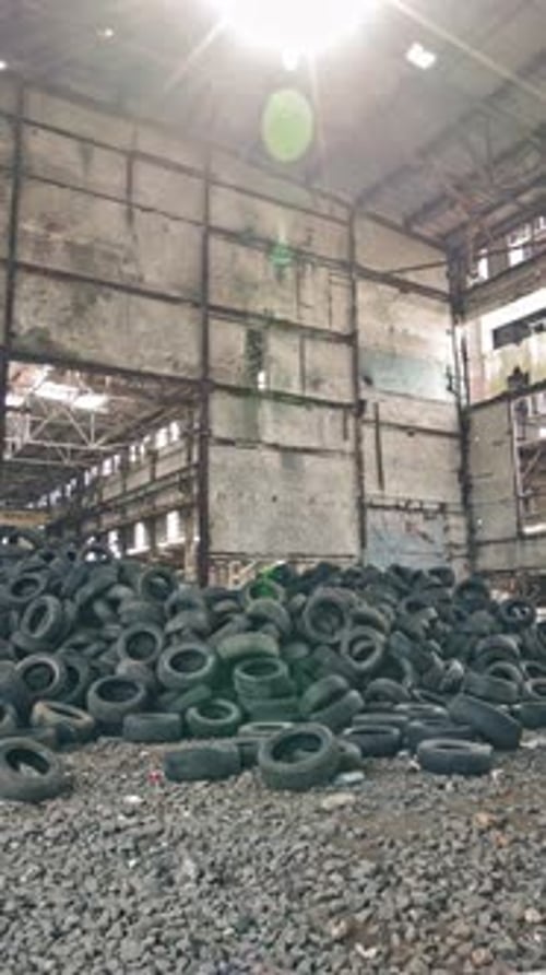 Wheel of cars in recycling. Old rubber wheels for trash factory recycling. Vertical video