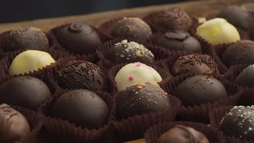 Delicious assortment of chocolate truffles in paper cups
