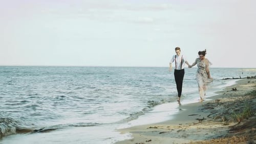 Happy Couple Together Running Through the Beach Side They Feeling Great and Very Romantic Holding