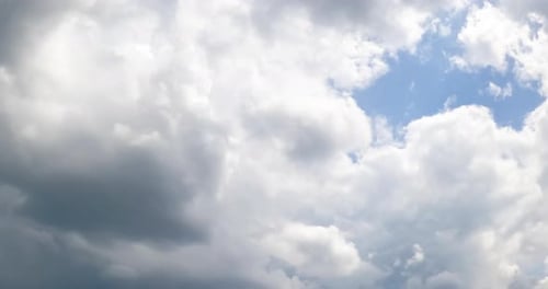 Rainy clouds accumulating in the sky. Dramatic cloudscape formation. Low angle view. Timelapse.