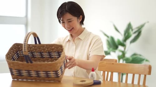 Happy Woman Crafting and Weaving a Basket