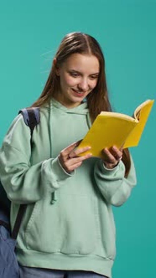 Vertical Video Young Girl Reading Book Enjoying Hobby Being Entertained