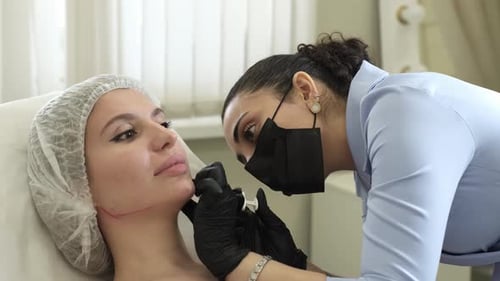 Woman Receiving Cosmetic Injection From Aesthetician