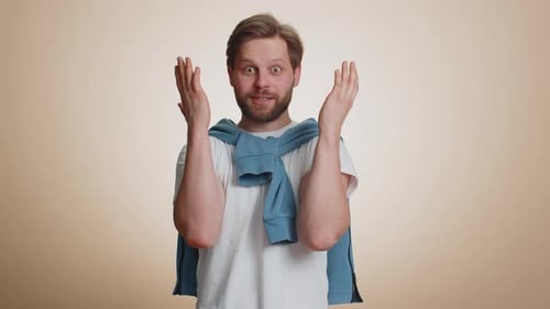 Man Gesturing Excitedly Wearing a Blue Sweater