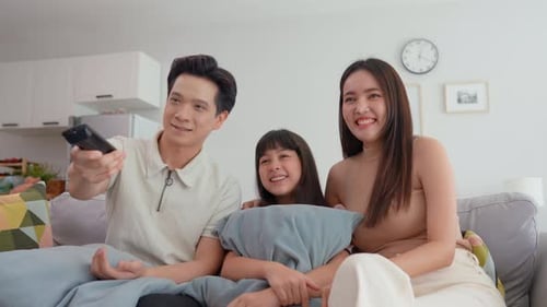 Happy Family Watching TV Together at Home