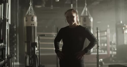 Cheerful Young Sportswoman Smiling in Gymnasium After Workout