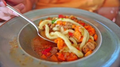 Close Up of Spoon Stirring Noodles and Vegetables