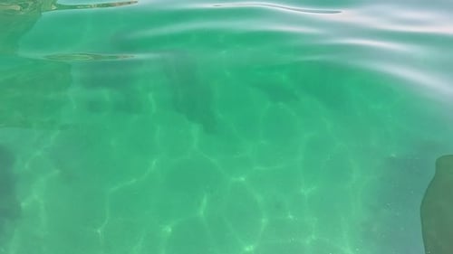 Sea Water Surface Background Low Angle View From Kayak Camera Flies Over the Clear Green Sea Water
