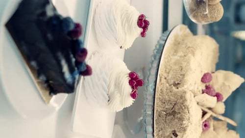 Close-up of sweet confectionery desserts behind a showcase.Cake, pastries, meringue in a shop window