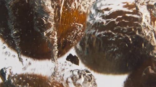Kiwis Sinking in Clear Water with Bubbles