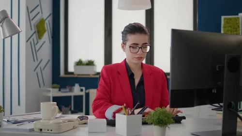 Office Worker Analyzing Business Charts and Graphs on Computer