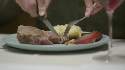 Raw steak sliced in a plate at a restaurant.