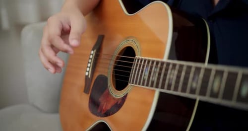Acoustic Guitar Playing Close Up Indoors