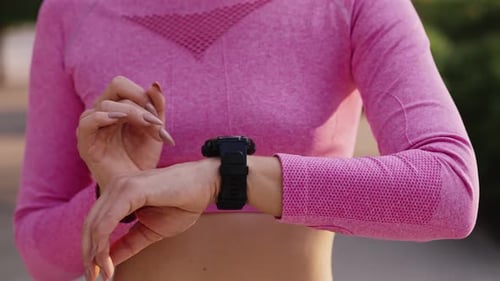Athletic Woman Using Smartwatch Outdoors Close Up