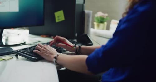 Focused Female Office Worker Typing On Computer In Office During The Daytime. Wide To Medium Shot...